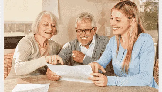 Older adults discussing dental care with a dental professional