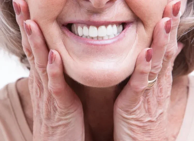 Patient smiling while wearing dentures